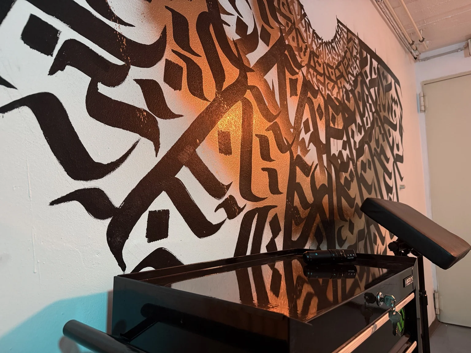 Graffitiwand und Tattoo-Werkzeugwagen im Studio